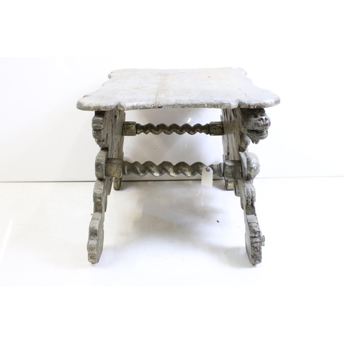 526 - Italianate Silver Painted Low Table with shaped top, raised on a base carved with lion masks, 76cm l... 