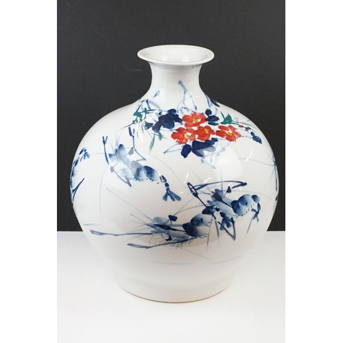 11 - Chinese ceramic vase of ovoid form, with floral decoration in red & blue on a white ground, six char... 