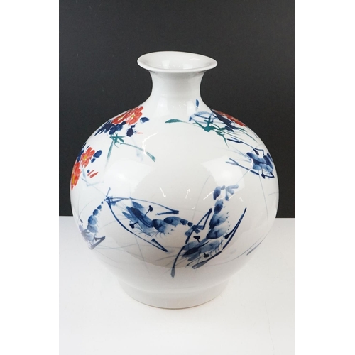 11 - Chinese ceramic vase of ovoid form, with floral decoration in red & blue on a white ground, six char... 