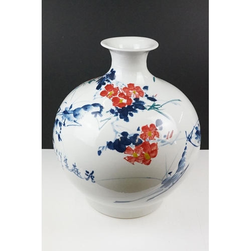 11 - Chinese ceramic vase of ovoid form, with floral decoration in red & blue on a white ground, six char... 