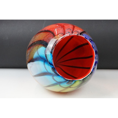 12 - Studio glass tapering vase with mottled rainbow swirl design within a clear glass casing (signed to ... 