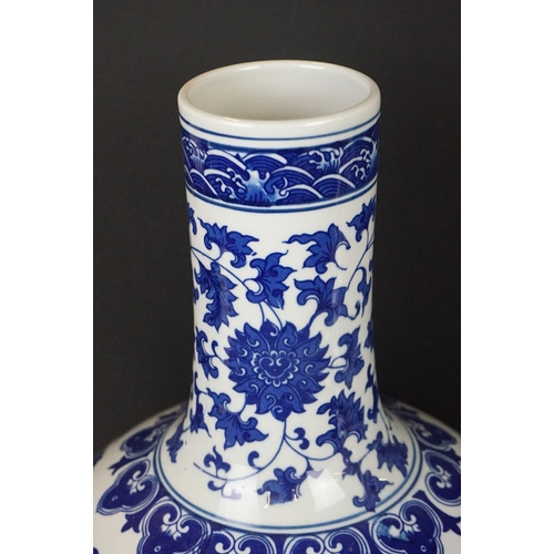 21 - Near pair of Chinese blue & white bottle vases, with scrolling floral and foliate decoration, each w... 