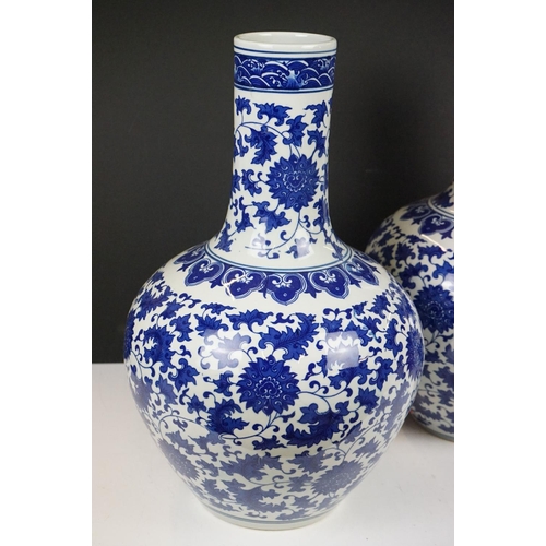 21 - Near pair of Chinese blue & white bottle vases, with scrolling floral and foliate decoration, each w... 