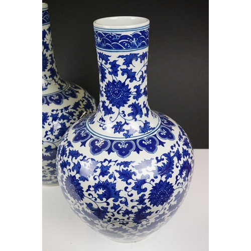 21 - Near pair of Chinese blue & white bottle vases, with scrolling floral and foliate decoration, each w... 