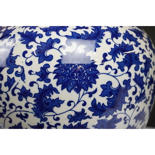 21 - Near pair of Chinese blue & white bottle vases, with scrolling floral and foliate decoration, each w... 