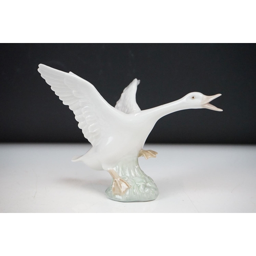 26 - Four Lladro porcelain figures to include 6175 White Swan, 1265 Duck Jumping and two standing geese