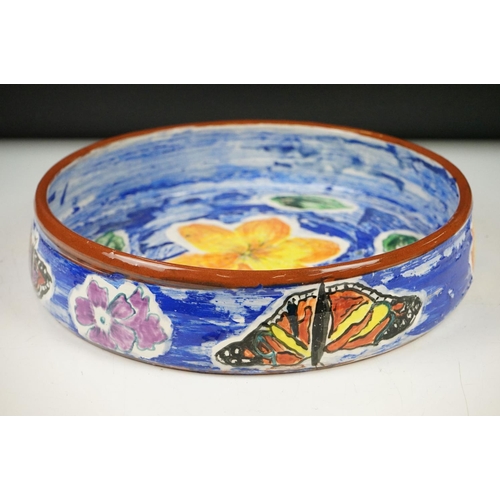 35 - Hazel Leach studio pottery circular bowl, with hand painted floral and butterfly decoration on a blu... 