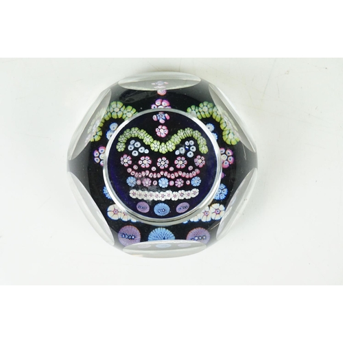 57 - Two Whitefriars QEII silver jubilee faceted glass millefiori paperweights, the millefiori canes depi... 