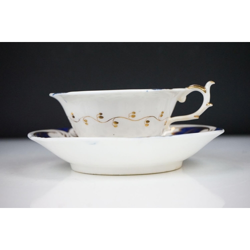 62 - Two 19th century Rockingham porcelain teacups & saucers to include an example decorated with cobalt ... 