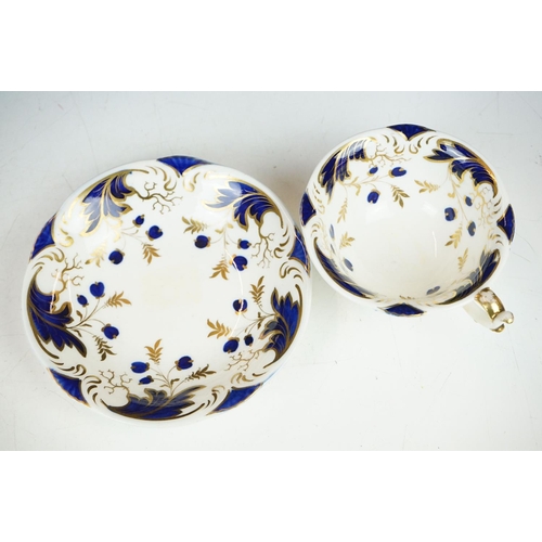 62 - Two 19th century Rockingham porcelain teacups & saucers to include an example decorated with cobalt ... 