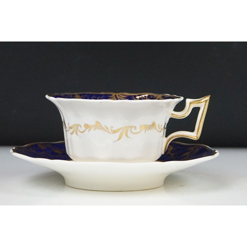 62 - Two 19th century Rockingham porcelain teacups & saucers to include an example decorated with cobalt ... 