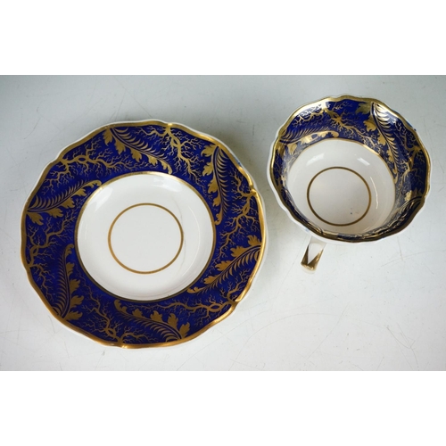 62 - Two 19th century Rockingham porcelain teacups & saucers to include an example decorated with cobalt ... 