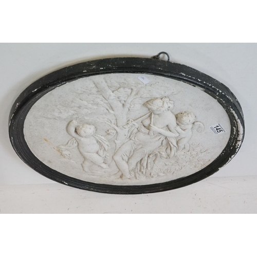 145 - Reconstituted stone circular wall plaque depicting a classical scene of a maiden and two putti. Appr... 