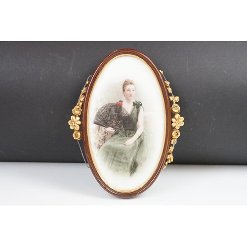 431 - Study of a seated lady holding a fan, on a porcelain plaque, 22 x 12cm oval, framed and glazed