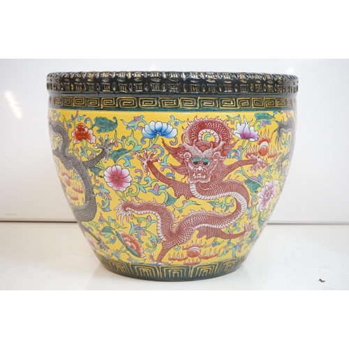 76 - Chinese yellow ground jardiniere, with enamel decoration depicting dragons amongst scrolling foliage... 