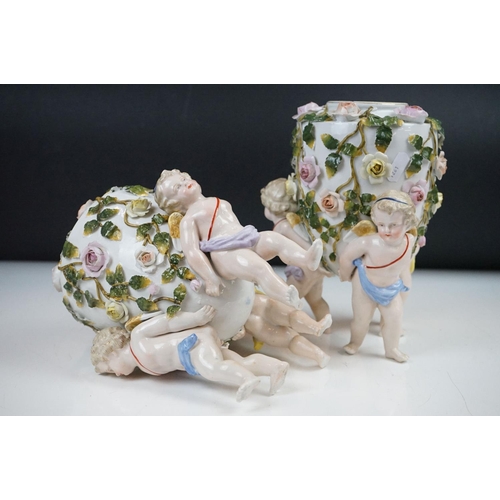 86 - Pair of 19th century Sitzendorf floral encrusted vases, each raised upon three putti (approx 21.5cm ... 