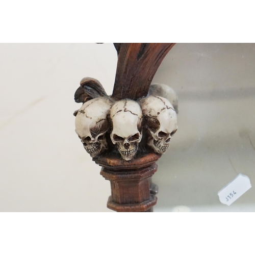 347 - A contemporary gothic style mirror with skeleton decoration.