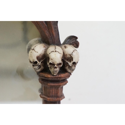 347 - A contemporary gothic style mirror with skeleton decoration.