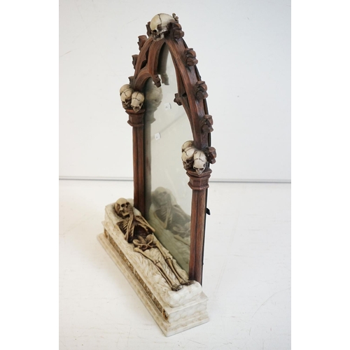 347 - A contemporary gothic style mirror with skeleton decoration.