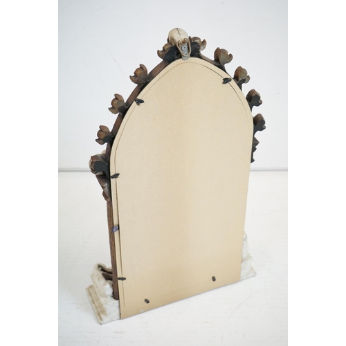 347 - A contemporary gothic style mirror with skeleton decoration.