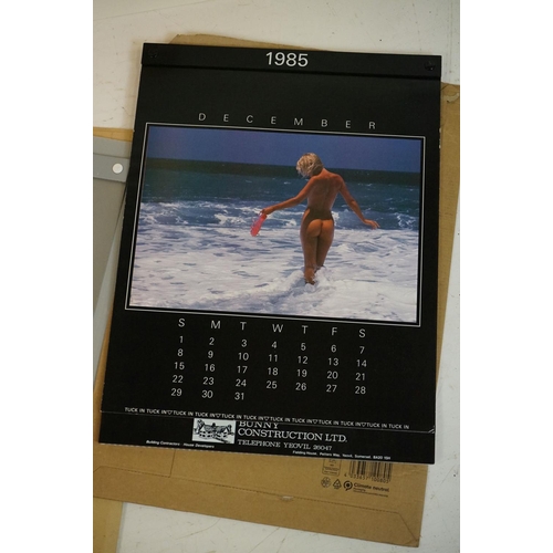 372 - A small selection of wall hanging calendars with erotic images to include a Pirelli example.