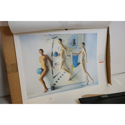 372 - A small selection of wall hanging calendars with erotic images to include a Pirelli example.