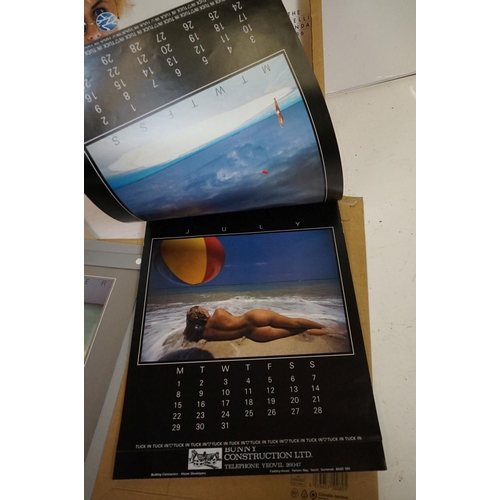 372 - A small selection of wall hanging calendars with erotic images to include a Pirelli example.