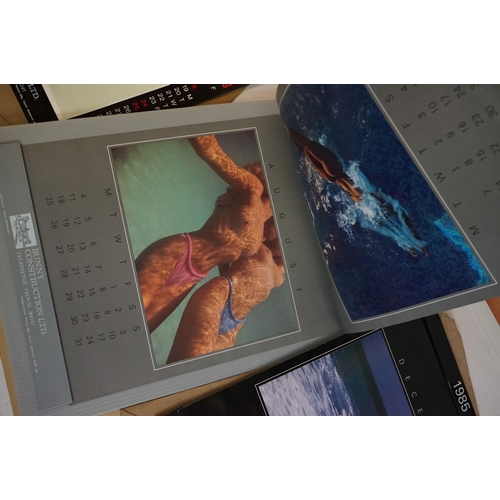 372 - A small selection of wall hanging calendars with erotic images to include a Pirelli example.