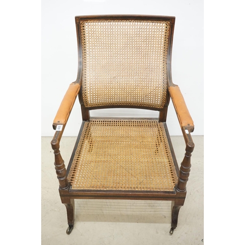 466 - Mahogany Inlaid Library Bergere Armchair in the Regency manner with shaped back and padded arm rests... 