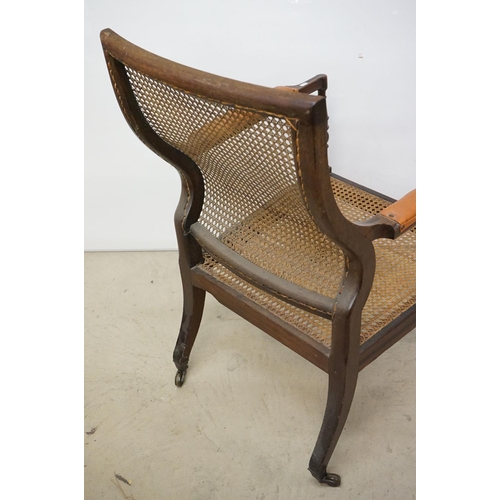 466 - Mahogany Inlaid Library Bergere Armchair in the Regency manner with shaped back and padded arm rests... 