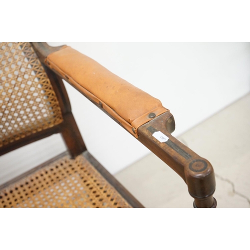 466 - Mahogany Inlaid Library Bergere Armchair in the Regency manner with shaped back and padded arm rests... 