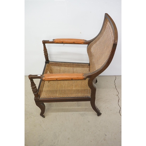 466 - Mahogany Inlaid Library Bergere Armchair in the Regency manner with shaped back and padded arm rests... 