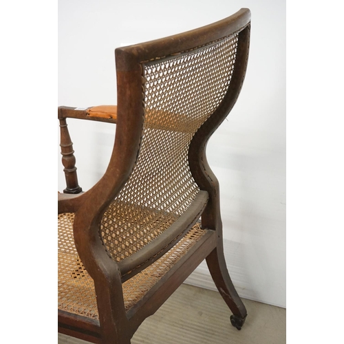 466 - Mahogany Inlaid Library Bergere Armchair in the Regency manner with shaped back and padded arm rests... 