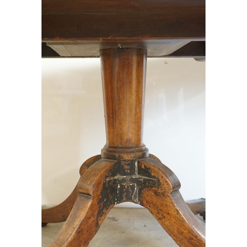 510 - Early 19th century Mahogany Rectangular Tilt Top Dining Table raised on turned pedestal with four sw... 