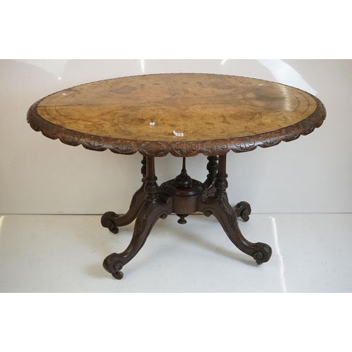 513 - Victorian Burr Walnut Oval Tilt Top Loo Table raised on four turned supports and four carved legs wi... 