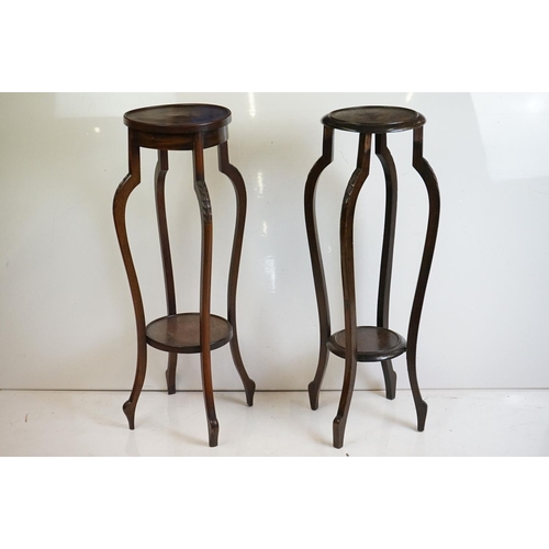 525 - Two similar Early 20th century Mahogany Jardiniere Stands, both with circular tops over four carved ... 