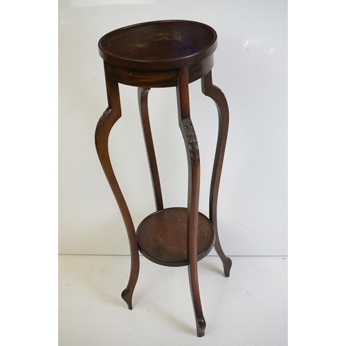 525 - Two similar Early 20th century Mahogany Jardiniere Stands, both with circular tops over four carved ... 