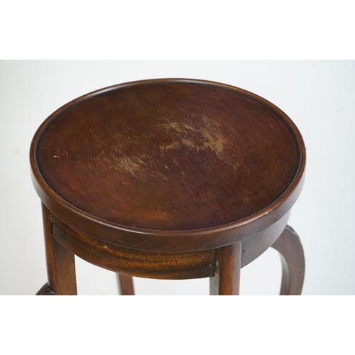 525 - Two similar Early 20th century Mahogany Jardiniere Stands, both with circular tops over four carved ... 