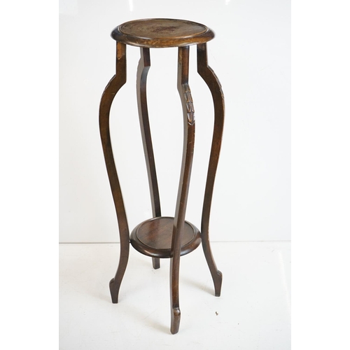 525 - Two similar Early 20th century Mahogany Jardiniere Stands, both with circular tops over four carved ... 