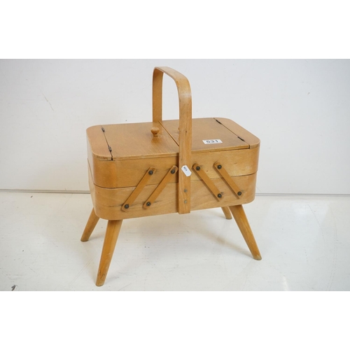 531 - Mid century Beech wood Concertina Sewing Box with carry handle and raised on four turned legs, 36cm ... 