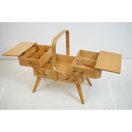 531 - Mid century Beech wood Concertina Sewing Box with carry handle and raised on four turned legs, 36cm ... 