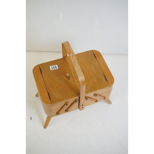 531 - Mid century Beech wood Concertina Sewing Box with carry handle and raised on four turned legs, 36cm ... 