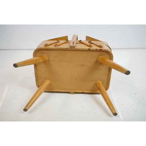 531 - Mid century Beech wood Concertina Sewing Box with carry handle and raised on four turned legs, 36cm ... 