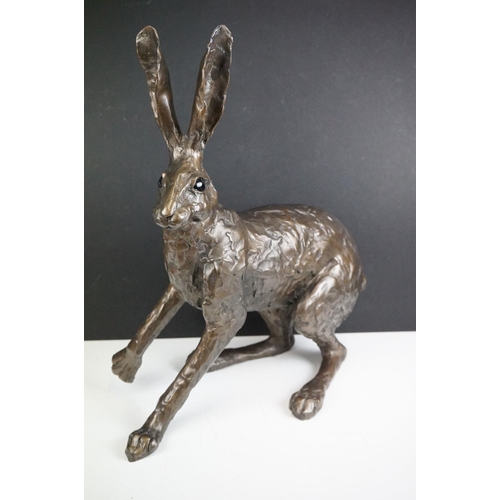 194A - A large sculpted composite Hare, signed PJ to back leg, stands approx 50cm in height (ear a/f)