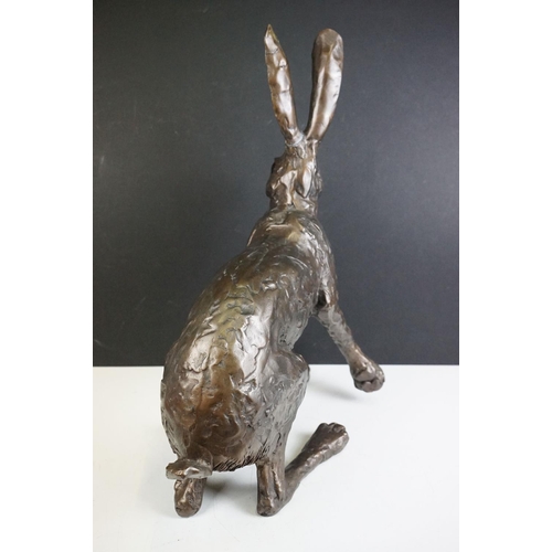 194A - A large sculpted composite Hare, signed PJ to back leg, stands approx 50cm in height (ear a/f)