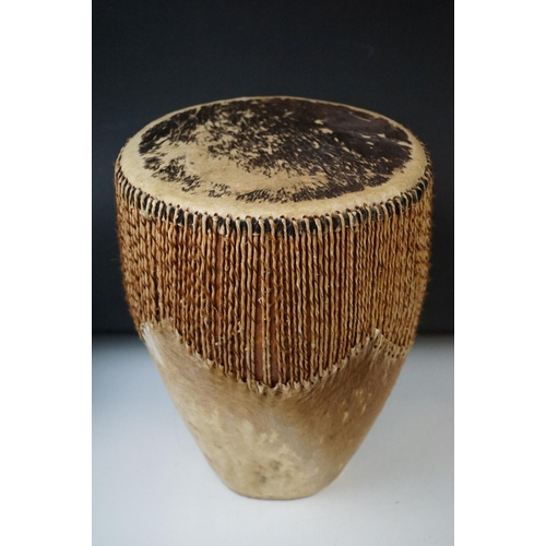 316 - A group of African tribal collectables to include a drum, marriage stick, fly whisk and musical inst... 