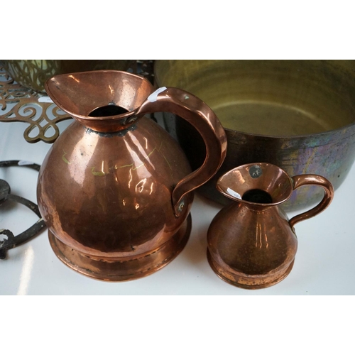 318 - A collection of mixed brass and copper ware to include two brass preserve pans, two copper jugs and ... 