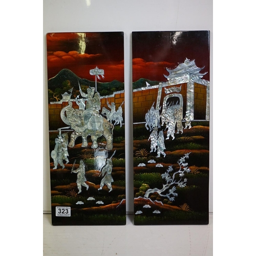 323 - A Japanese lacquerware four piece hanging wall plaque set with mother of pearl figures and animals.