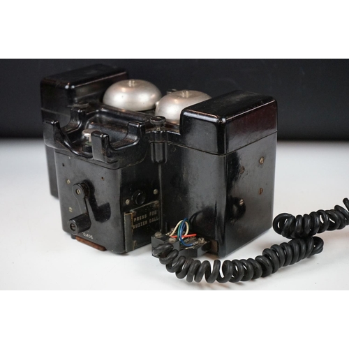 325 - A British military field telephone in original battlefield green storage case.