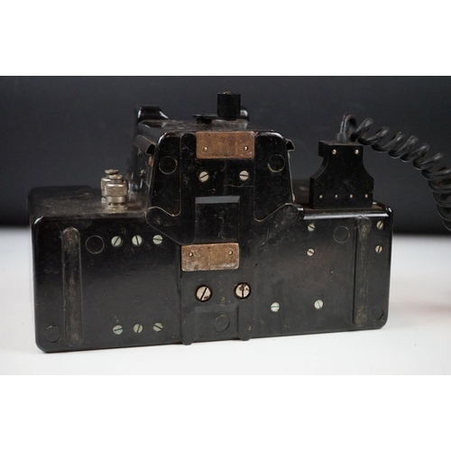 325 - A British military field telephone in original battlefield green storage case.